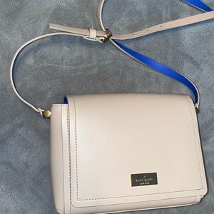Nude Kate Spade crossbody bag with blue interior flap with adjustable strap